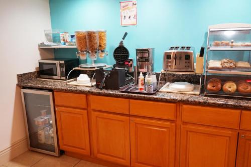 a kitchen with a counter with some food on it at Howard Johnson by Wyndham Salinas in Salinas