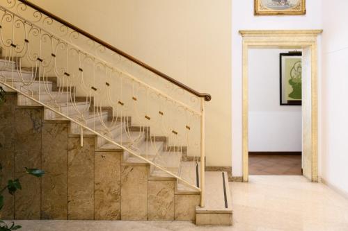 a staircase in a house with wooden railings at Hotel Continental in Treviso