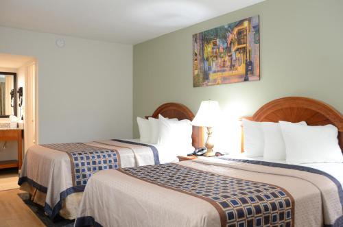 a hotel room with two beds in a room at Smart Stay Inn - Saint Augustine in Saint Augustine