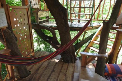 a hammock tied to a tree in a tree house at River Side Cabana in Tissamaharama