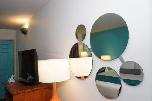 a room with three mirrors on the wall at Howard Johnson by Wyndham Salinas in Salinas