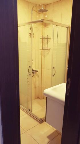 a shower with a glass door in a bathroom at Waha Hotel in Bursa