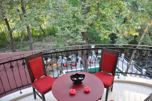 a table and two chairs on a balcony with a table at Villa Bella Boutique Hotel in Kavadarci