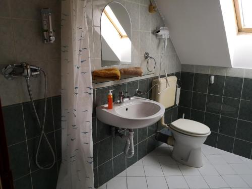 a bathroom with a sink, toilet and bathtub at Apartman116 Airport in Vecsés