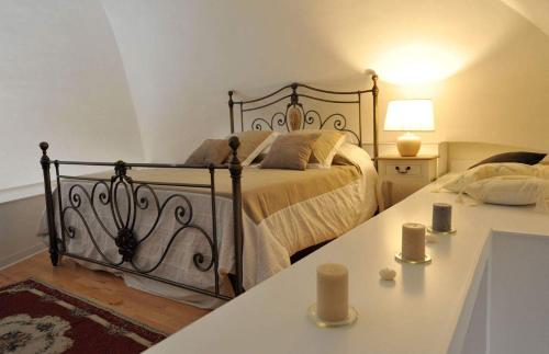 a bedroom with a bed and a table with candles at ARCOBELLO Suite Rooms in Castellana Grotte