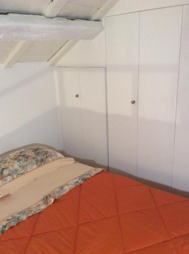 a bedroom with white cabinets and a orange floor at Old castle S. Croce in Cagliari