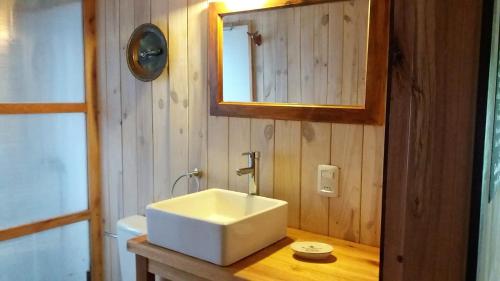 a bathroom with a white sink and a mirror at Salitre solo para parejas y familias in La Pedrera