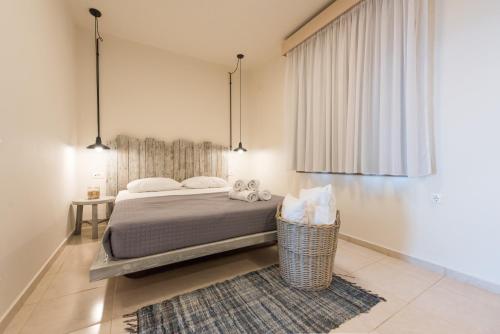 a bedroom with a bed and a rug and two lights at Eva Mare Hotel & Suites - Adults only in Agia Pelagia