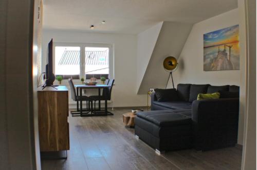 a living room with a couch and a table at Pura Vida Fehmarn in Fehmarn