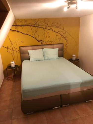 een slaapkamer met een bed met een gele muur bij Maison de vacances à Westende in Middelkerke
