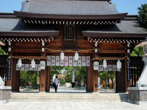 a person walking in front of a pagoda at Hotel Wing International Kobe - Shinnagata Ekimae in Kobe