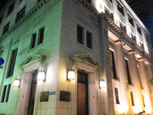 a building with lights on the side of it at Hotel Wing International Kobe - Shinnagata Ekimae in Kobe