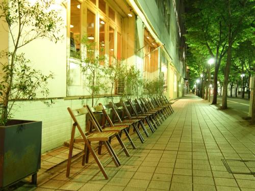 a row of benches sitting outside of a building at Hotel Wing International Kobe - Shinnagata Ekimae in Kobe