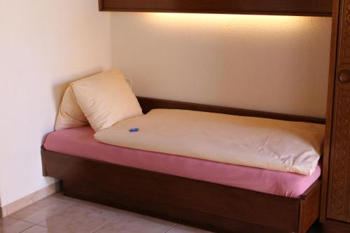 a small bed with a pillow on top of it at Hotel Glärnisch Hof in Horgen