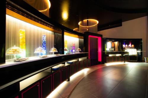 a restaurant with a bar with a pink lighting at Blue Hotel Octa (Adult Only) in Sapporo