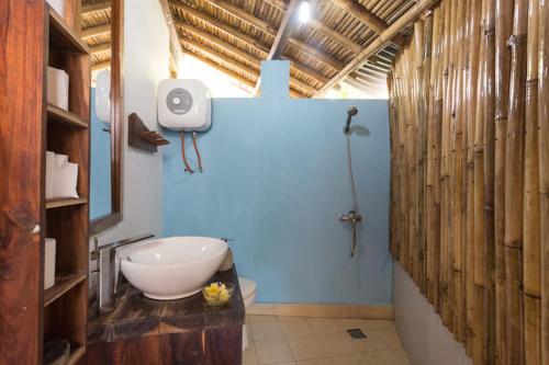 a bathroom with a sink and a toilet and a shower at Villa Monyet Java in Batukaras