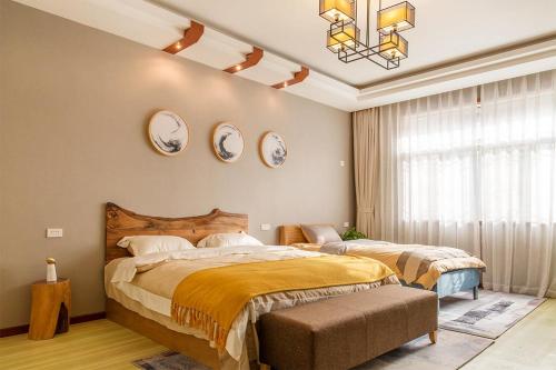 a bedroom with two beds and two mirrors on the wall at Henan Kaifeng·Millennium City· Locals Apartment 00139400 in Kaifeng