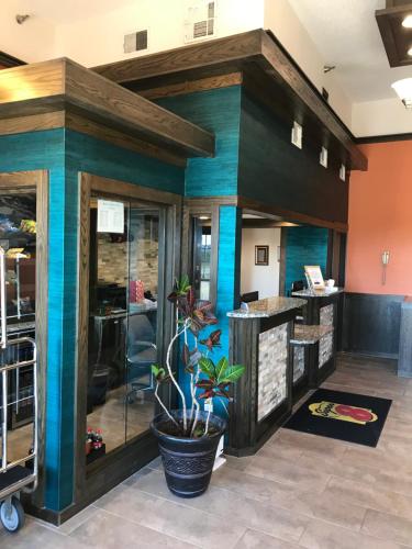 a lobby of a salon with blue and green painted walls at Super 8 by Wyndham Fayetteville in Fayetteville