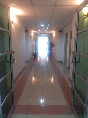 a hallway in a hospital with a light shining through a window at Arwana Inn Tok Bali in Pasir Puteh