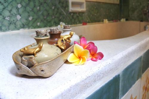 a group of vases and flowers sitting on a counter at Jogja Village in Yogyakarta