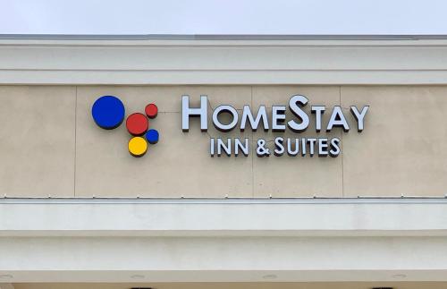 a sign for a home stay inn and suites on a building at HomeStay Inn & Suites Edinburg in Edinburg