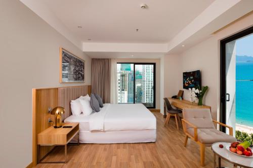 a hotel room with a bed and a desk at Nagar Hotel Nha Trang in Nha Trang