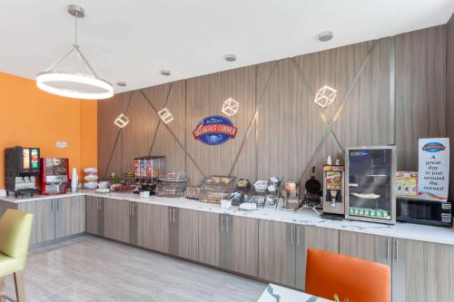 a fast food restaurant with a counter with food at Baymont by Wyndham Houston Hobby Airport in Houston