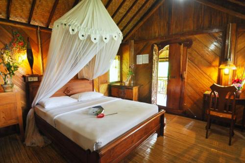 Katil atau katil-katil dalam bilik di Puri Lumbung Cottages Restaurant & Spa Munduk