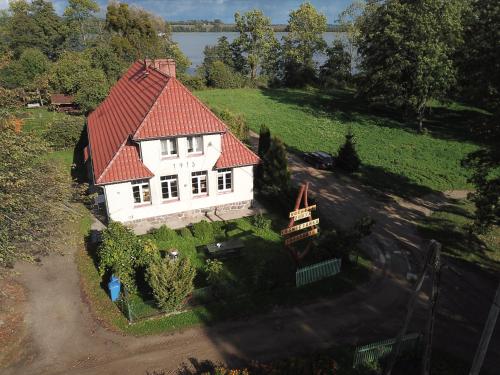 an aerial view of a white house with a red roof at Złota Leśniczówka in Rydzówka