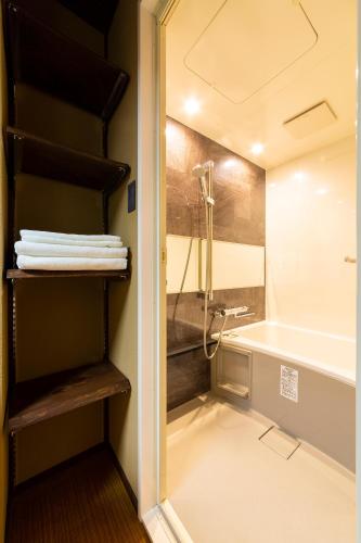 a bathroom with a shower and a sink and a tub at Higashiyama Sho in Kanazawa