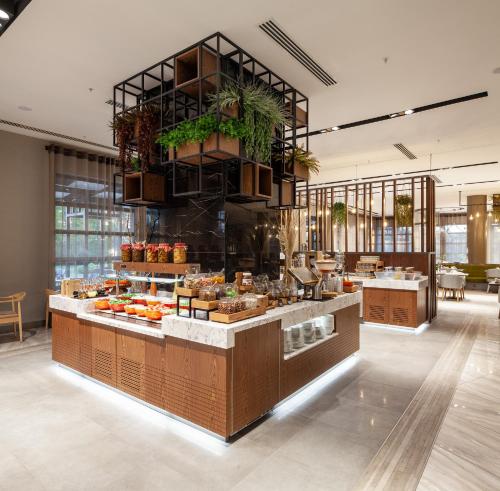 a restaurant with a counter with fruits and vegetables at Novotel Trabzon in Trabzon