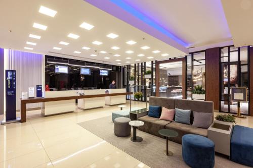 a lobby of a store with a couch and tables at Novotel Trabzon in Trabzon