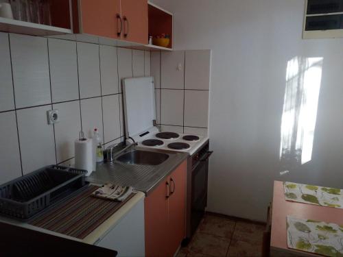 a small kitchen with a sink and a stove at city center apartment 1 in Niš