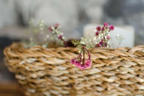 a basket with flowers in it with a candle at Rauriser Bergchalet in Rauris
