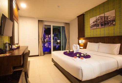 a hotel room with a bed with a bunny on it at Supicha Pool Access Hotel - SHA Plus in Phuket Town