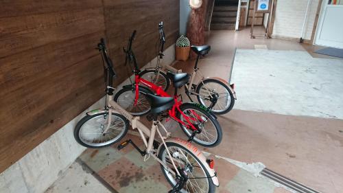 a group of three bikes parked in a room at Guesthouse Minami in Setouchi