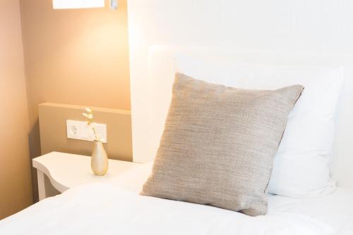 a pillow sitting on a bed next to a window at Fletcher Hotel-Restaurant de Wageningsche Berg in Wageningen