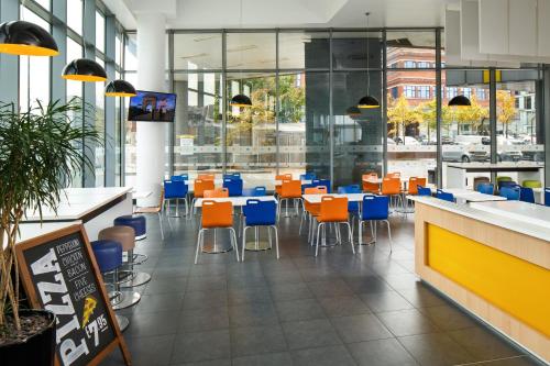 a dining room filled with tables and chairs at ibis Budget Manchester Centre Pollard Street in Manchester
