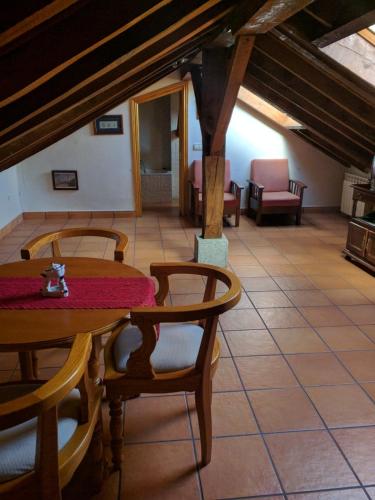 a room with a table and chairs in a building at Casa Rural Soportales de Peguerinos in Peguerinos