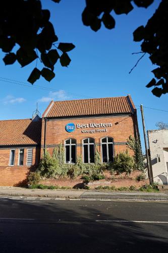 a best western building on the side of a street at Best Western The George Hotel, Swaffham in Swaffham