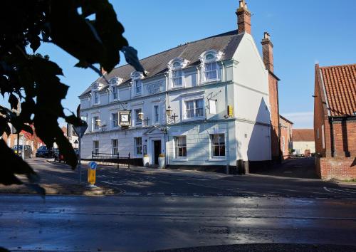a white building on the side of a street at Best Western The George Hotel, Swaffham in Swaffham