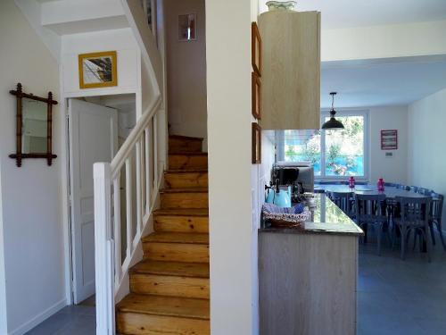 a kitchen and a hallway with a staircase in a house at Villa Violaine in Sassetot-le-Mauconduit