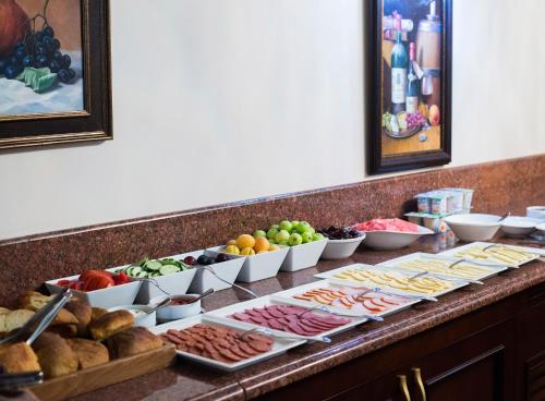 a buffet with different types of food on a counter at Elegant Hotel & Resort in Tsaghkadzor