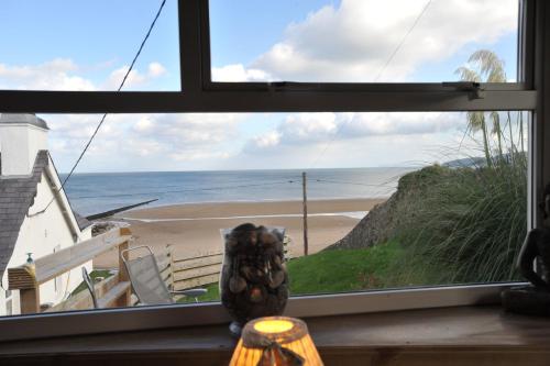 a view of a beach from a window at Sea View Guest House in Benllech
