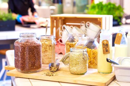 a wooden table with jars of food on it at Stayokay Hostel Arnhem in Arnhem