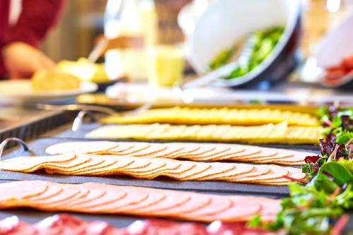 a bunch of different types of food on a table at Stayokay Hostel Arnhem in Arnhem