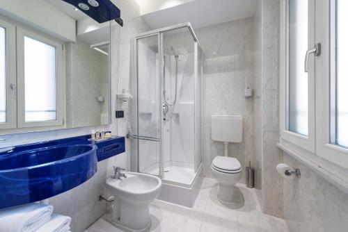 uma casa de banho com um chuveiro, um WC e um lavatório. em Mastino Rooms em Verona