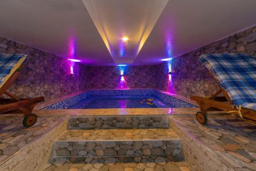 a swimming pool in a room with purple lights at Vision Deluxe Hotel in Istanbul