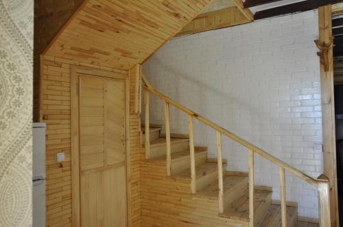 a wooden staircase in a room with a brick wall at Fairy Tale in Gabala