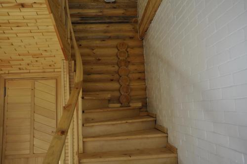 a wooden staircase in a room with a brick wall at Fairy Tale in Gabala